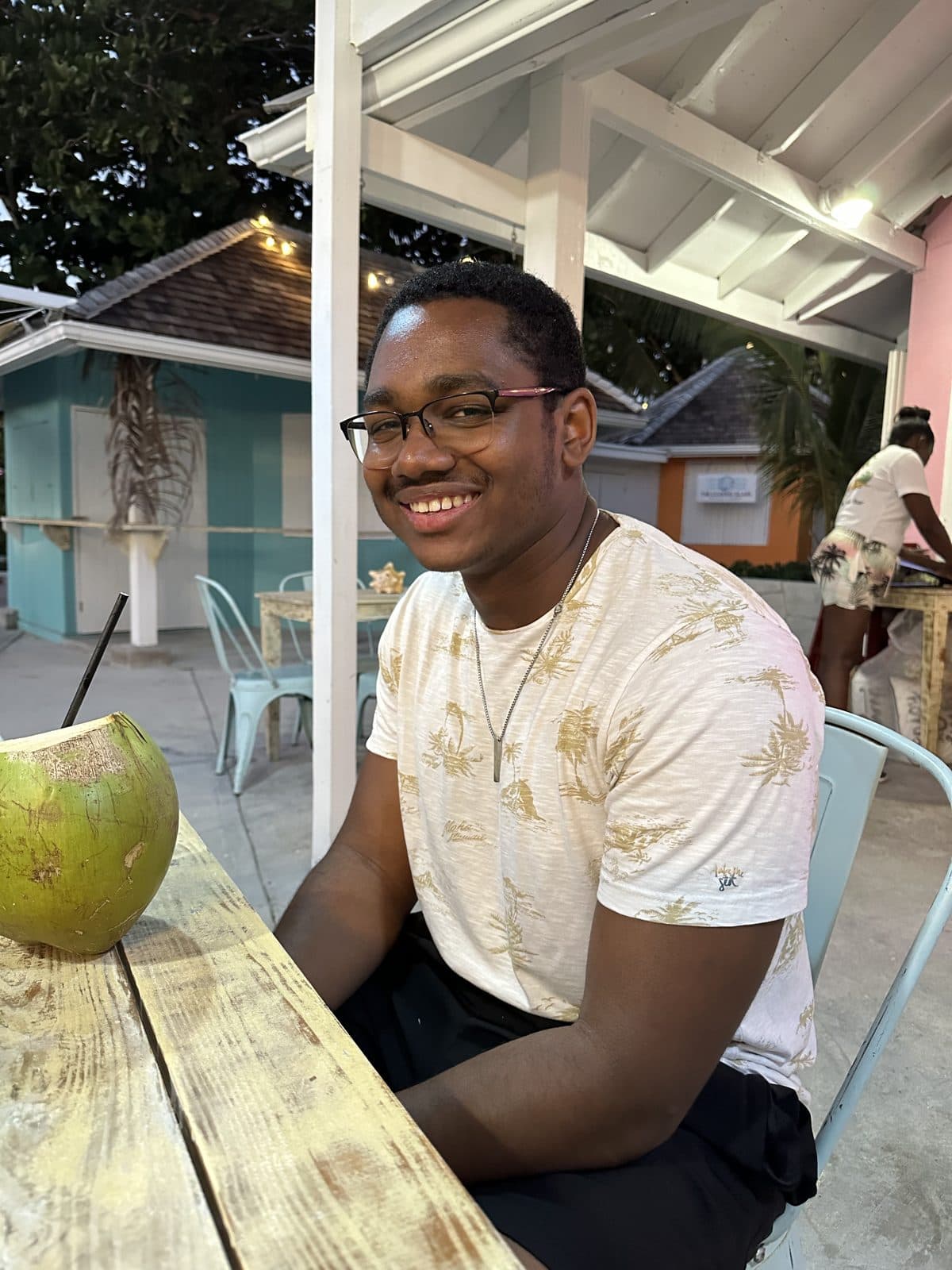 Sujar Henry smiling at a beachside café